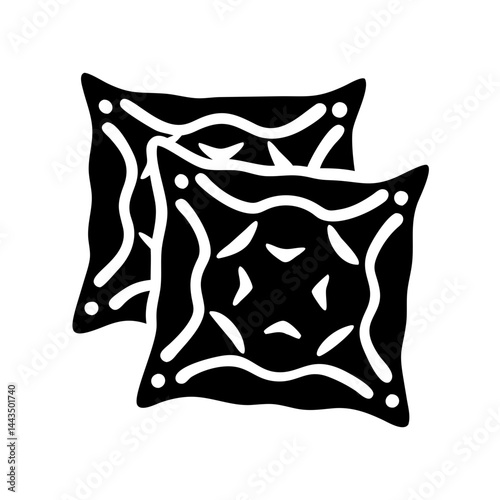 Two ornamental pillows with symmetrical design elements in black and white