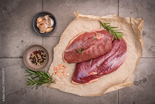 Obraz na płótnie Preparation for cooking raw duck breast with ingredients on dark background, top view. Space for text. High quality photo w salonie
