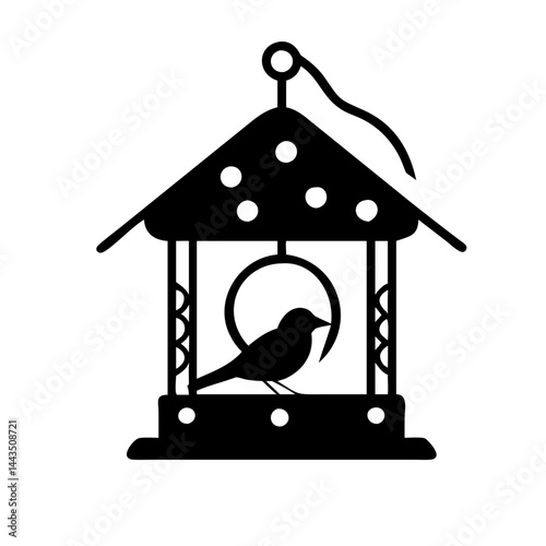 Silhouette of bird feeder with bird perched inside in black and white