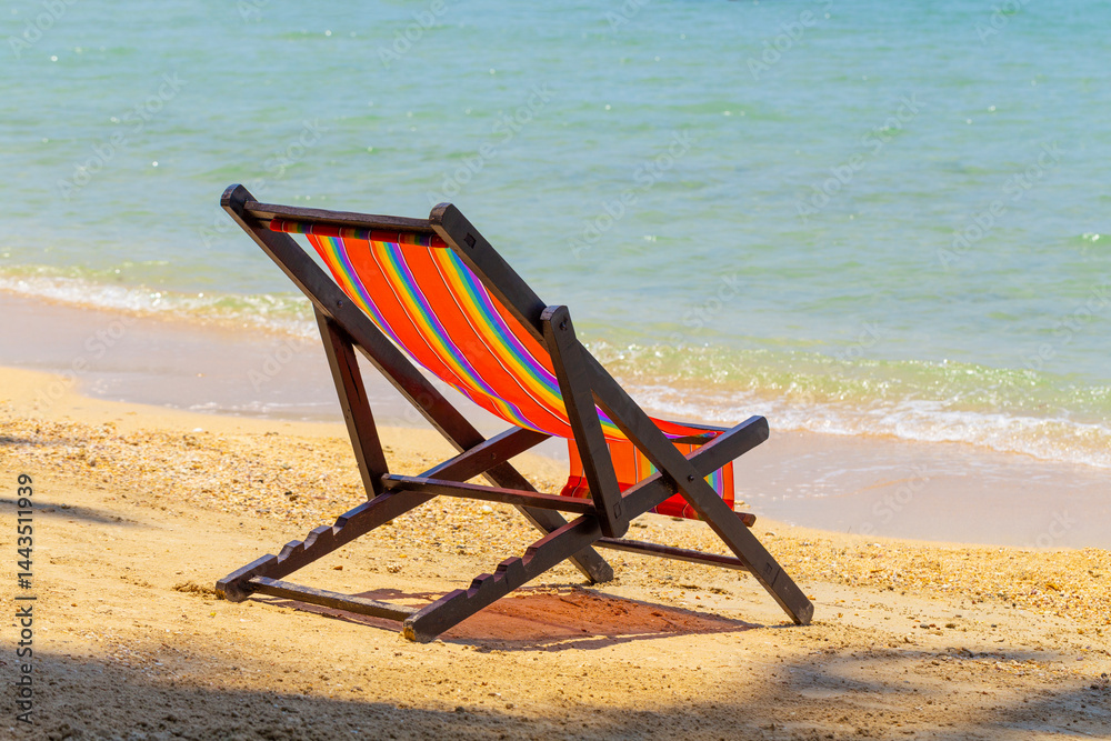 sun beach chairs on shore near sea.