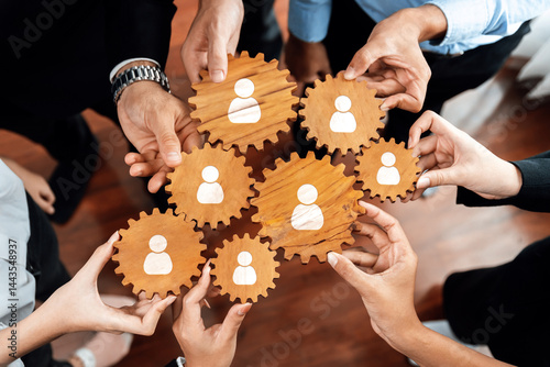 A dynamic visual of hands holding wooden gears, symbolizing teamwork and collaboration in professional networking, showcasing connection and shared goals for success. Amity