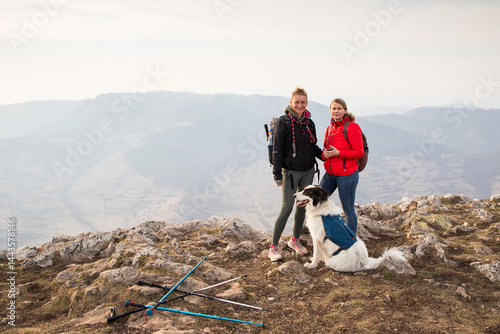 Obraz na płótnie happy fit woman trekking with her dog w salonie