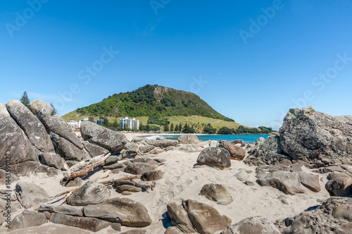 Obraz na płótnie Rocky foreground on Moturiki Island on Main Beach with landmark Mount Maunganui in background. w salonie