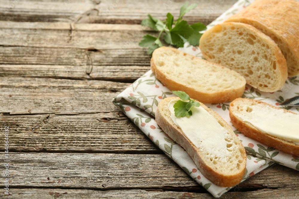 Pieces of bread with butter and parsley on wooden table. Space for text Pieces of bread with butter and parsley on wooden table. Space for text