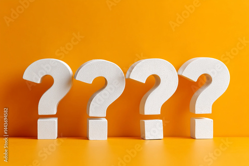 Question marks on orange background showing four white question marks standing next to each other in a row on an orange surface