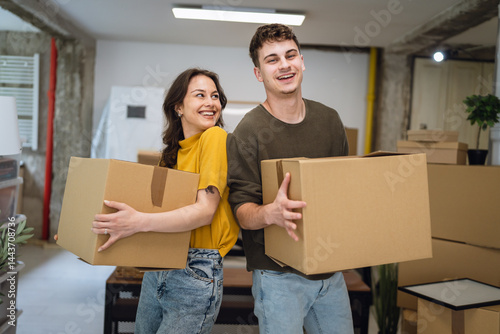 Bild auf Leinwand Portrait of laughing proud couple in love hold box on relocation day,