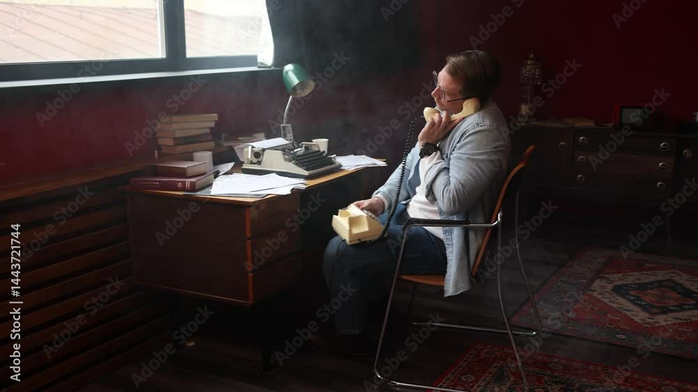 Writer in vintage office on phone call, surrounded by typewriter and papers in cinematic soft lighting.