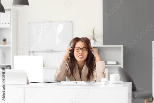 Stressed Asian businesswoma...