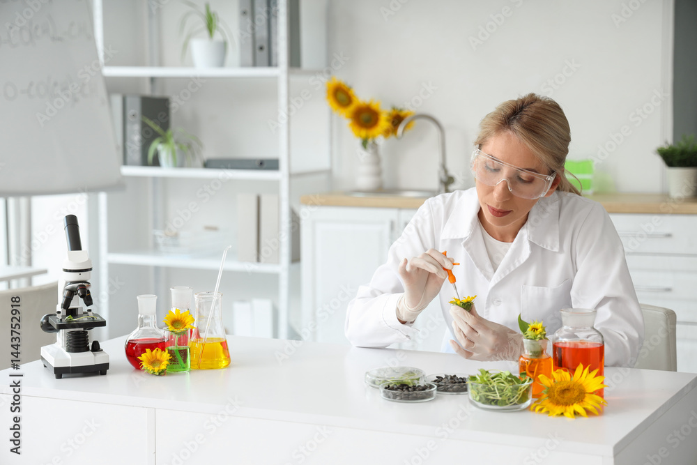 Female scientist with flasks of samples, sunflower seeds and sprouts working in laboratory Female scientist with flasks of samples, sunflower seeds and sprouts working in laboratory