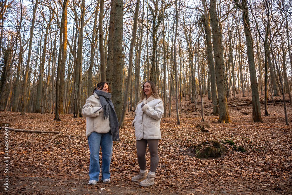 Two female friends on a walk in the forest. Friends walking through the forest. People in nature. Two female friends on a walk in the forest. Friends walking through the forest. People in nature.