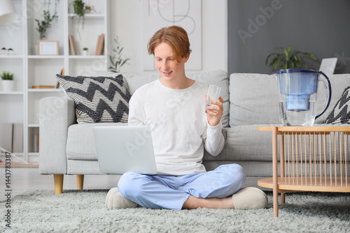 Young man with glass and wa...