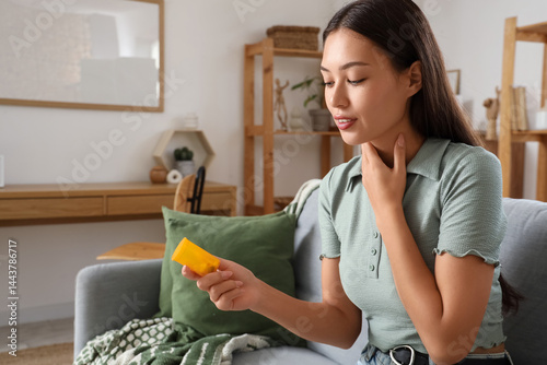 Young Asian woman with pill...