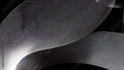 Captivating movement of light and shadow intertwines in an abstract presentation. Flowing shapes and textures interact against a dark background, showcasing artistic design and creativity