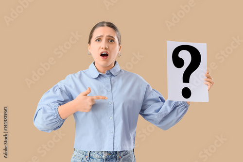 Puzzled woman holding paper...