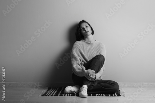 Depressed young woman sitti...
