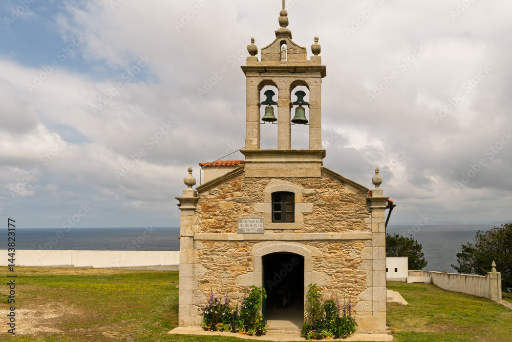 Fototapeta premium A small church with a bell tower and a sign on the front
