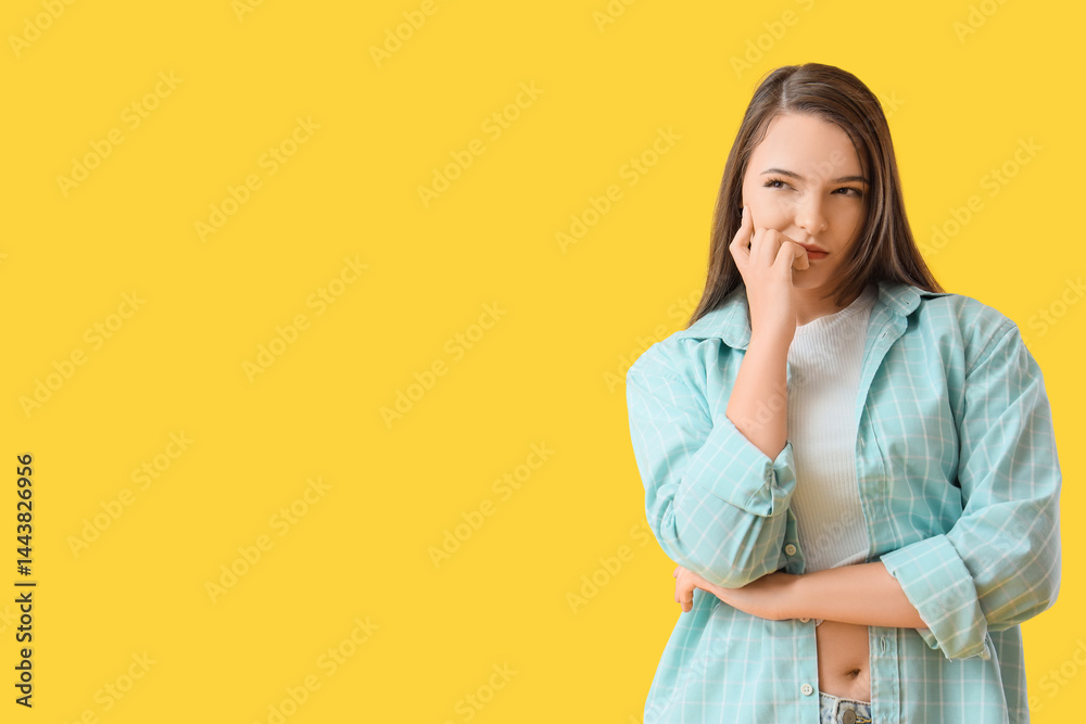Wondering young woman with paper question mark on yellow background Wondering young woman with paper question mark on yellow background