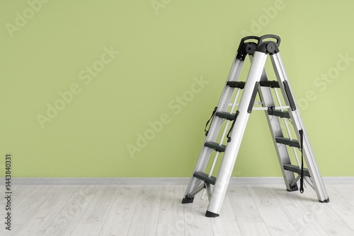 Metal stepladder near green...