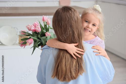 Happy little girl hugging m...