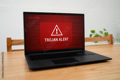 Laptop screen with urgent trojan alert. Malware infection on corporate computer.