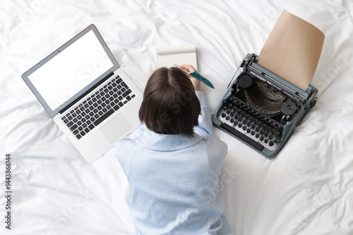 Woman in pajamas with noteb...