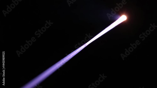 Bright Blue and Purple Light Beam Against Dark Background