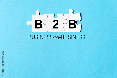 Obraz na płótnie Business concept image with letters B2B written on white jigsaw puzzles means business to business, isolated on blue background w salonie