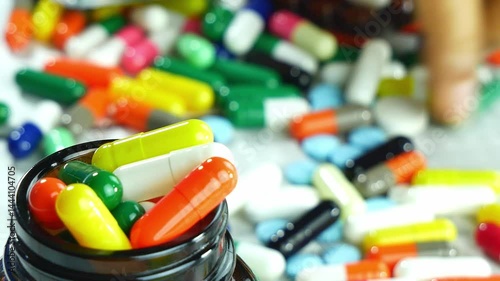 Many capsules in bottles and on the table.