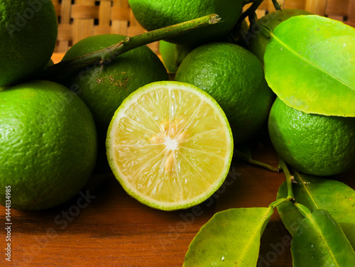 Close up of fresh lime with leaves, whole and half, green limes, natural, fruit