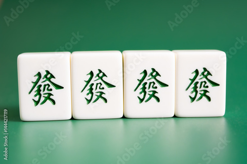 Close-up of mahjong tiles on a green surface,Mahjong (mah jongg, mah-jongg, and mahjongg) is a tile-based game that was developed in the 19th century in China