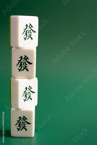 Close-up of mahjong tiles on a green surface,Mahjong (mah jongg, mah-jongg, and mahjongg) is a tile-based game that was developed in the 19th century in China