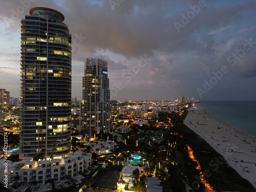 Cityscape of downtown Miami at night light. Tropical paradise in South Beach. Midnight city lights in Miami. Waterfront view of Miami skyline. Aerial shot of Miami at sunrise. Neon Art Deco. Ocean