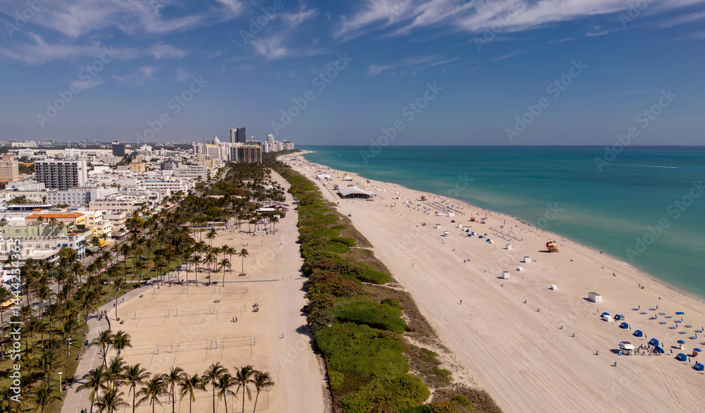 Beach in Miami with sunbed on a sandy beach with ocean waves. Miami Beach paradise with stunning views. South Beach Miami lifeguard post. Peaceful seaside retreat in Miami. Coastal relaxation.