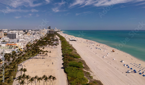 Beach in Miami with sunbed on a sandy beach with ocean waves. Miami Beach paradise with stunning views. South Beach Miami lifeguard post. Peaceful seaside retreat in Miami. Coastal relaxation.