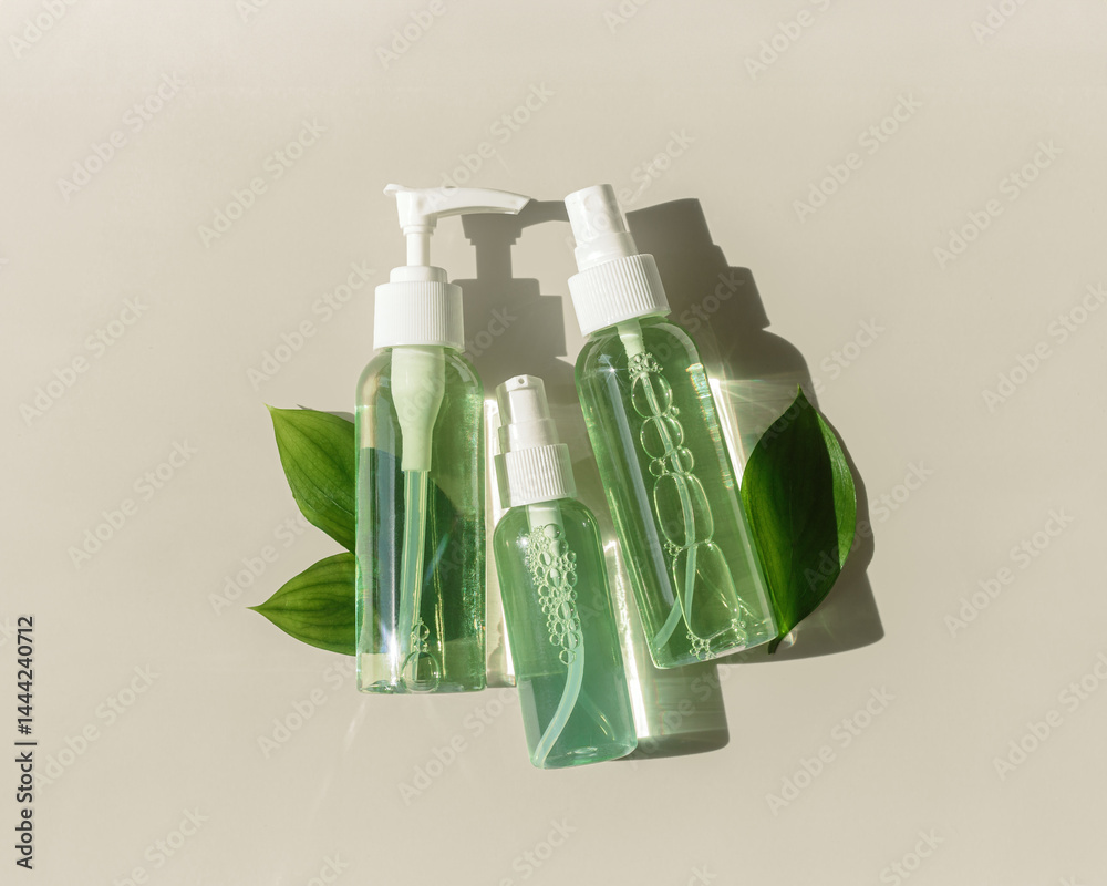 Natural Organic Cosmetic products with green liquid for skin treatment, beauty routine, skin health. Minimal top view with lotion, tonic, gel, micellar water mockup with shadow, aesthetic flat lay