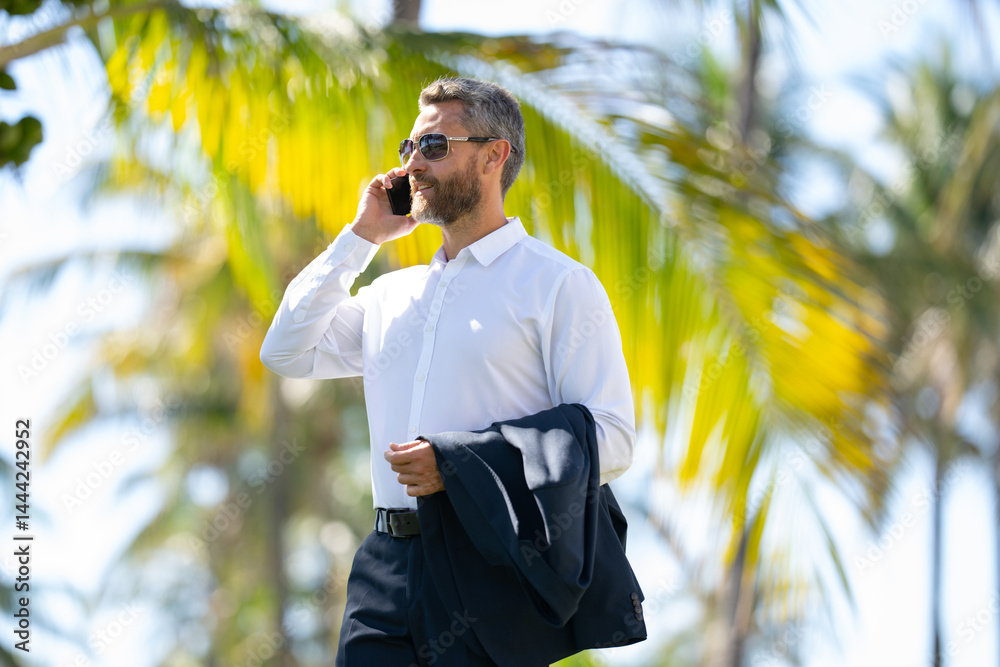 Hot business. Summer business. Business man on summer palm street. Businessman in summer. Mature stylish freelancer outdoors portrait. Handsome business man in casual wear on vacation.