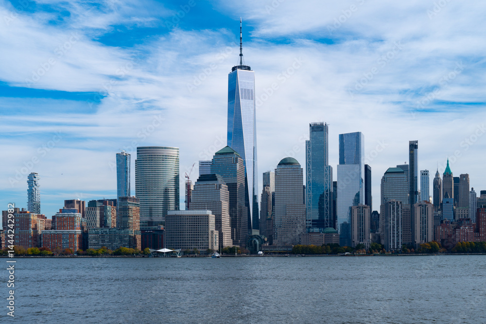New York City cloudy skyline. NYC skyscrapers. Manhattan. NY cityscape with clouds. Downtown New York buildings. NYC skyline on clouds. New York harbor view. Skyscrapers in Manhattan. NYC downtown.