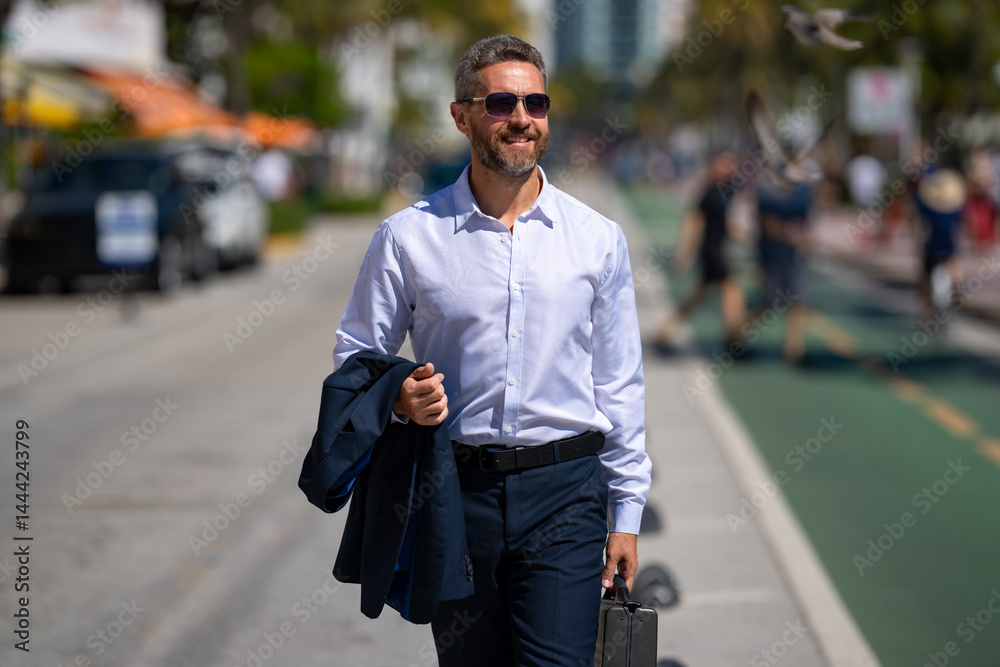 Businessman walking confidently in the city. Businessman walking down the street. Handsome businessman walking on way to the office. Confident entrepreneur businessman walking outdoors.
