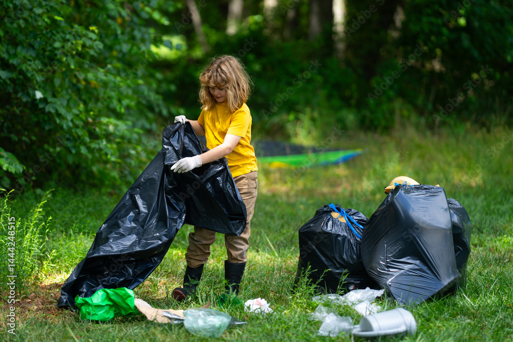 Child picking plastic trash for cleaning the nature. kid Clean up garbage outdoor. Ecology concept. Environment Day. Save earth. Recycling bin garbage. Ecology. Environmental care. Eco kid.