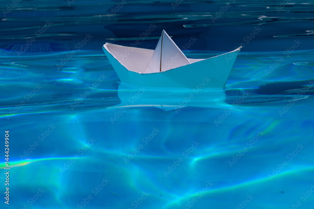 Paper boat on the sea background. Tourism, travel dreams vacation holiday. Cruise ship concept. Origami paper sailing boat. Paper craft and origami.