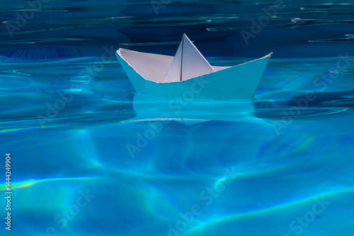 Obraz na płótnie Paper boat on the sea background. Tourism, travel dreams vacation holiday. Cruise ship concept. Origami paper sailing boat. Paper craft and origami. w salonie