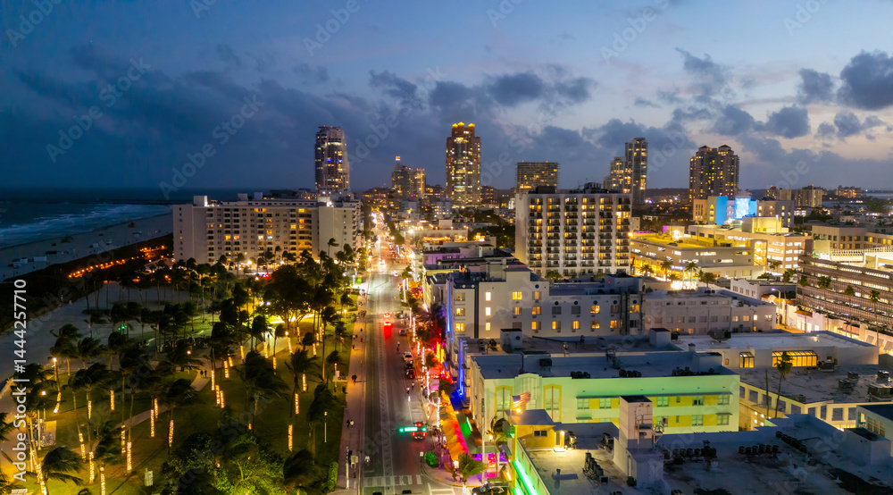 Miami Beach sunset aerial view. Downtown Miami skyline at dusk. South Beach neon lights at night. Tropical Miami waterfront panorama. Ocean Drive Art Deco buildings. Aerial view of Miami coastline.