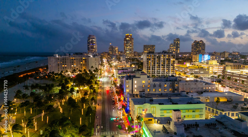 Obraz na płótnie Miami Beach sunset aerial view. Downtown Miami skyline at dusk. South Beach neon lights at night. Tropical Miami waterfront panorama. Ocean Drive Art Deco buildings. Aerial view of Miami coastline. w salonie