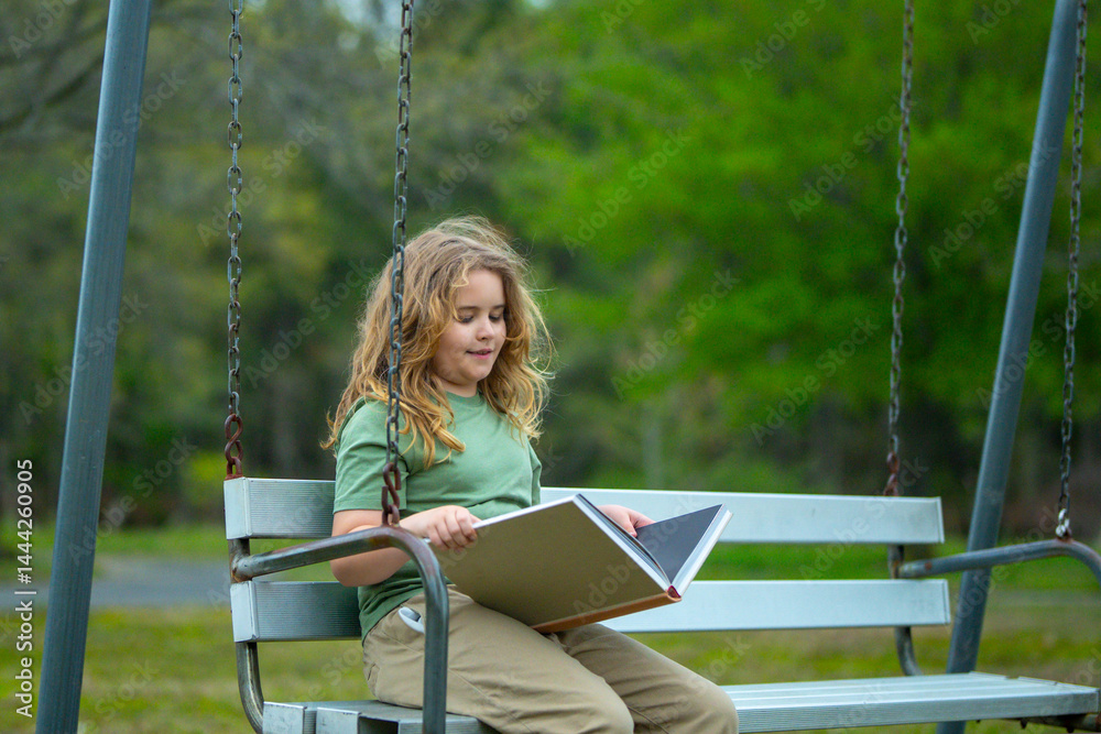 Kid reading book in outdoors. Child read story outdoors. Portrait of teen reading in nature. Boy with book studying on bench. Kid reading book. Child reading book in peaceful park.