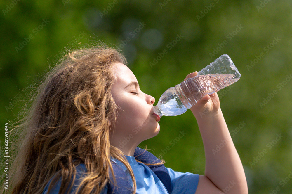 Child drinking water from bottle. Kid refreshing with drink. Thirsty child drink water from plastic bottle. Close-up of thirsty kids face. Fresh water in nature. Pure water bottle for thirsty kid.