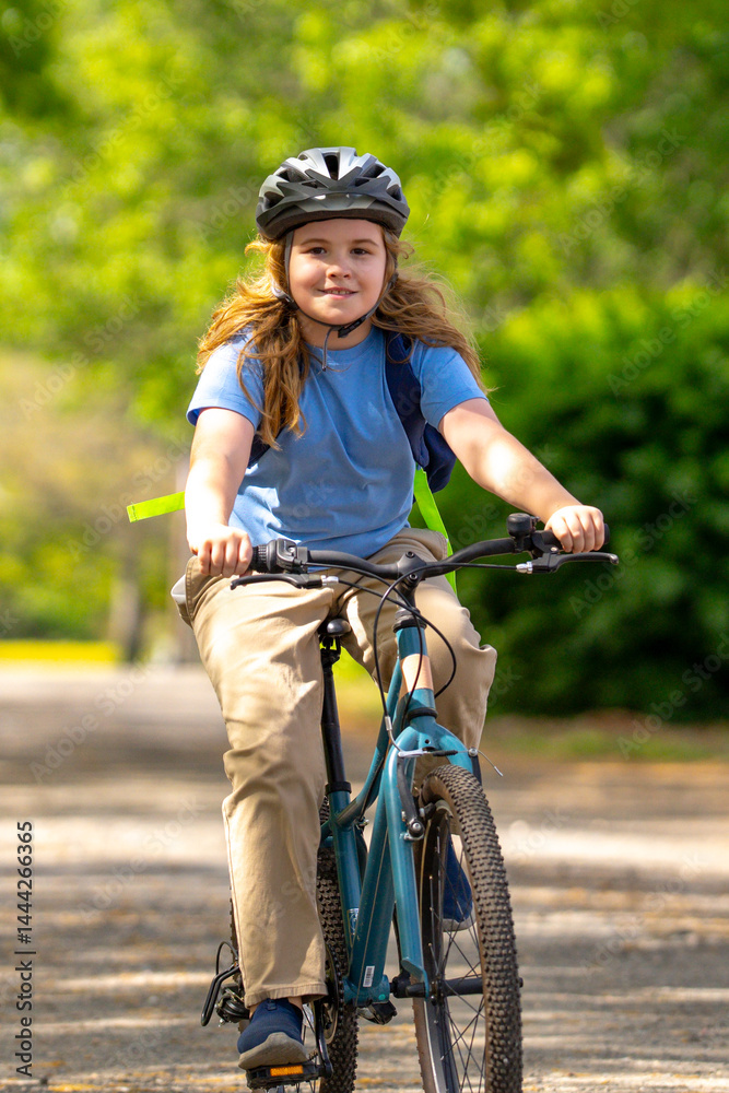 Child bike ride. Teen boy biking down summer road. Kid riding bicycle with smile. Child cycling. Kid ride on bike. Happy boy on bike. Child biking outdoors. Children biking. Little biker.