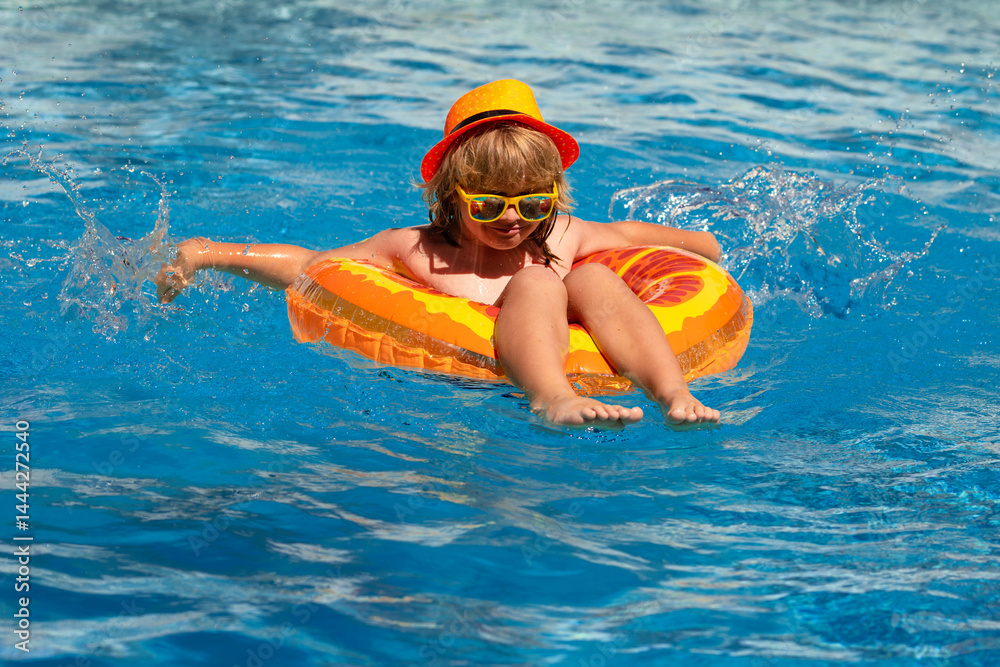 Child play in pool in summer day. Children playing in swimming pool. Summer holidays and vacation concept.