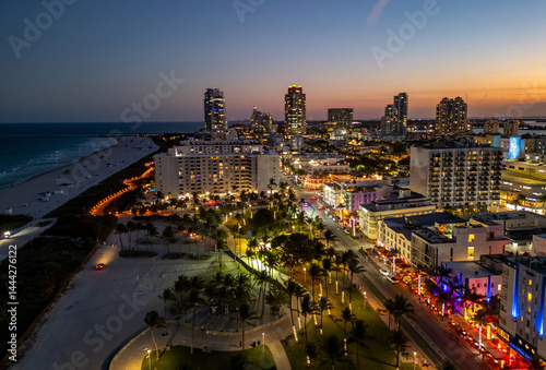 Obraz na płótnie Miami skyline with ocean view. Sunset over South Florida beaches. Drone view of cityscape. Illuminated Miami skyline at night. Panoramic night of Miami waterfront. Famous landmarks of Miami Beach. w salonie