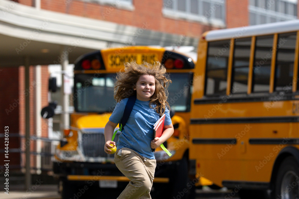 School bus waiting for child student outdoors. Blonde kid with backpack and note books to go school. Outdoor walk to public school. Education, studying and knowledge concept in American school.
