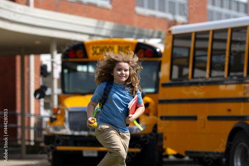 Obraz na płótnie School bus waiting for child student outdoors. Blonde kid with backpack and note books to go school. Outdoor walk to public school. Education, studying and knowledge concept in American school. w salonie